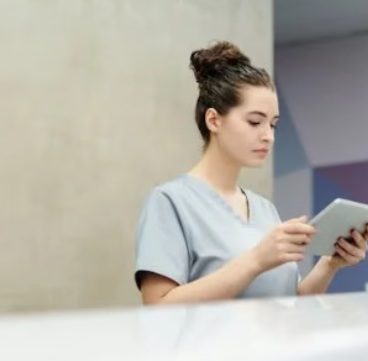 Clinic staff reviewing patient details on tablet